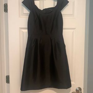 Beautiful black cocktail dress. With pockets pleated waist. Cap sleeve